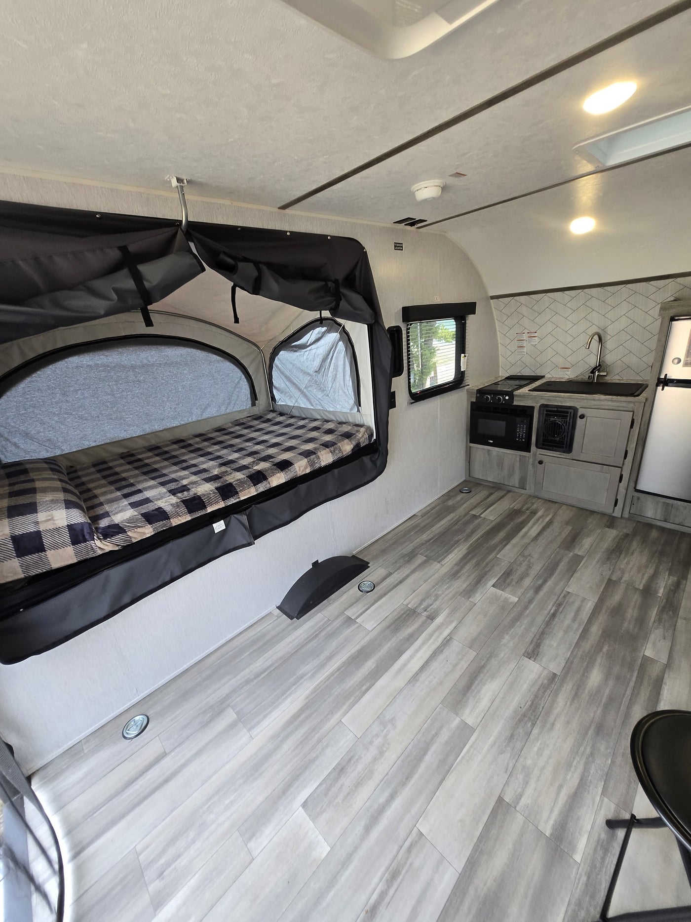 surrounded by pine trees.|An rv rental (Go Lite Boulderback) by a tranquil lake — photo 3
