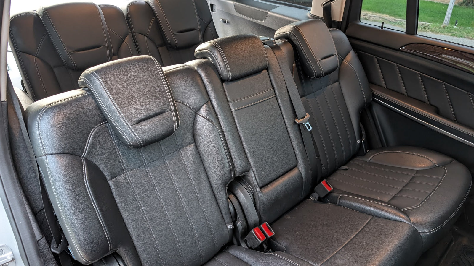 Clean black leather car seats and headrests in a spacious vehicle interior, ready for your next road trip or rv rental.