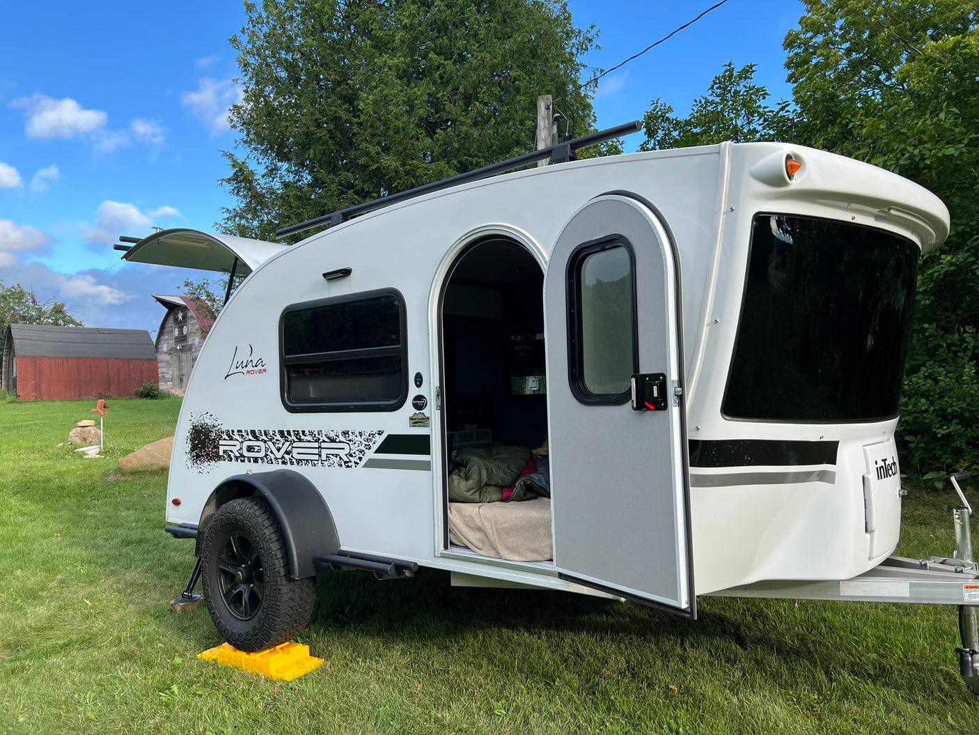 keeping drinks cold.|A gray camping cookware set with red handles sits on an RV rental stove