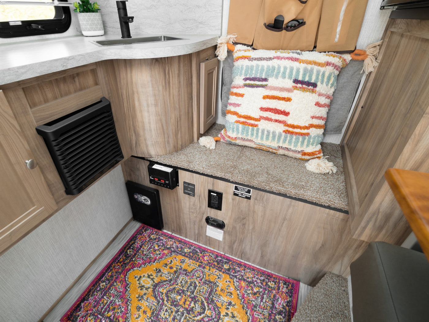 and a window view of vibrant autumn trees.|Experience comfort in this RV rental! Features a small kitchen — photo 7