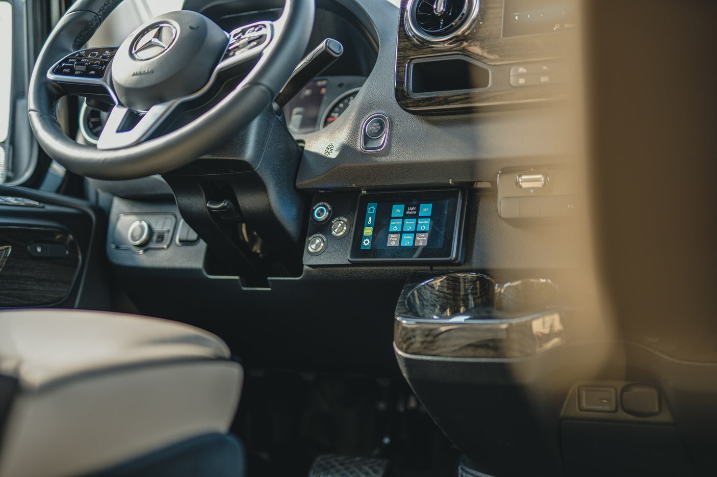 and cupholders.|Premium RV rental interior featuring cream quilted leather seats