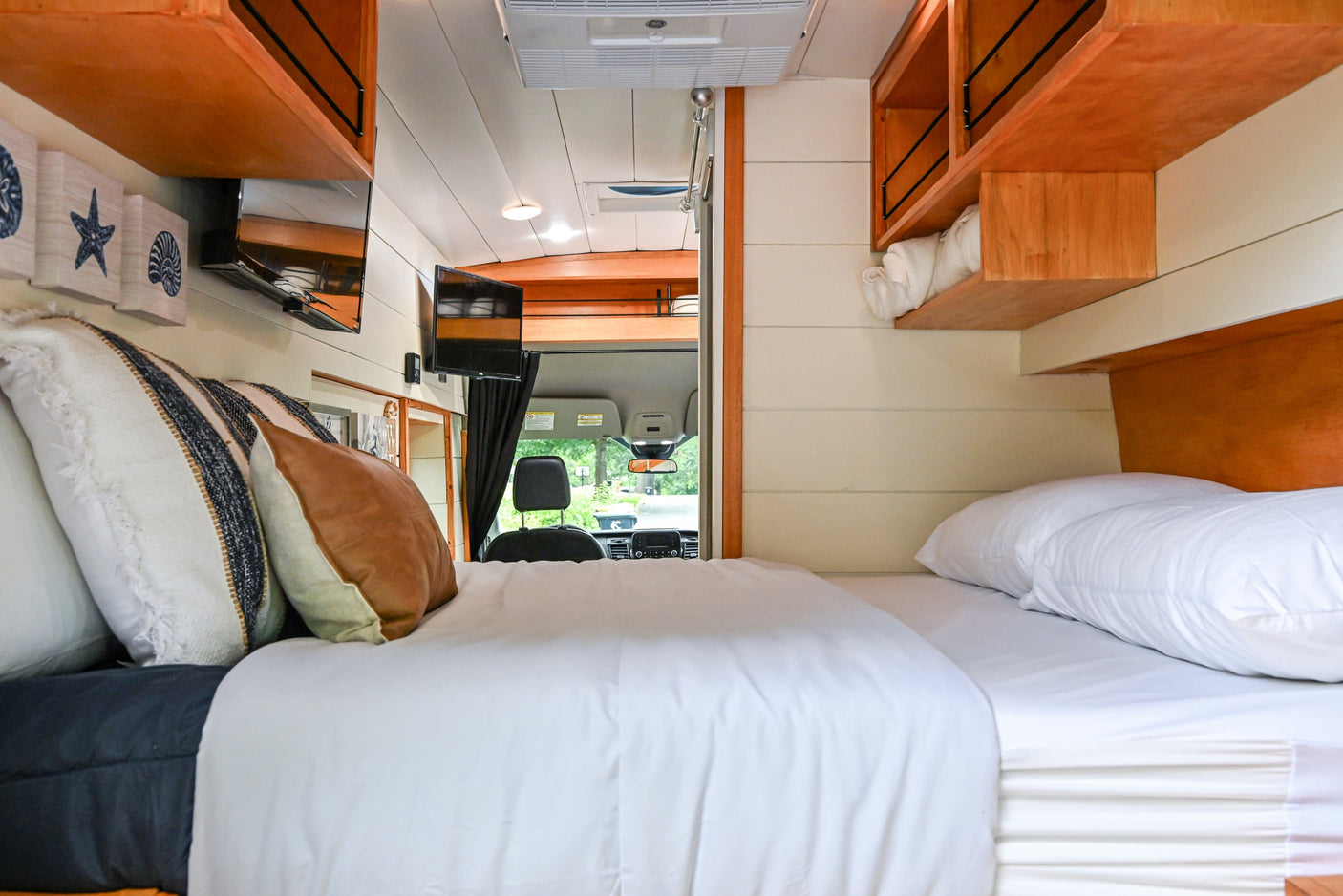 and cozy amenities.|Black Ford Transit RV rental: a fully equipped camper van with roof rack