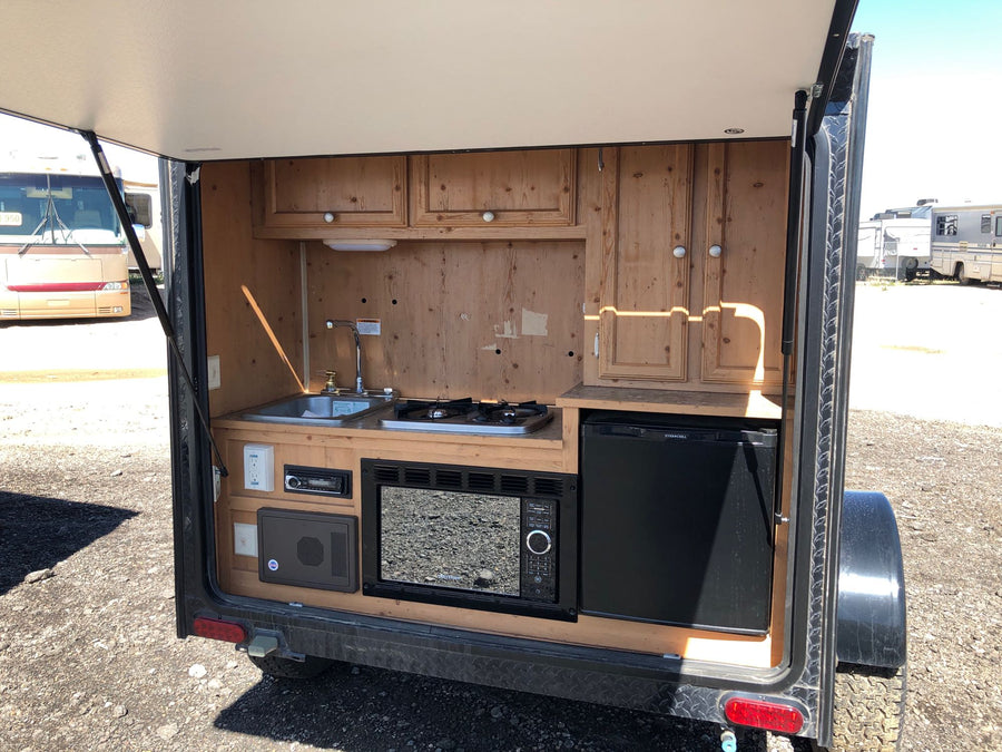 and stove.|This camouflaged off-road teardrop camper is ready for adventure