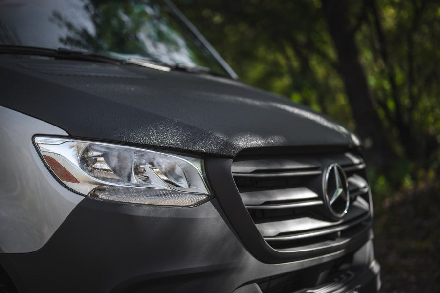 Close-up of a Mercedes-Benz Sprinter van with textured hood, ideal for your next rv rental adventure.