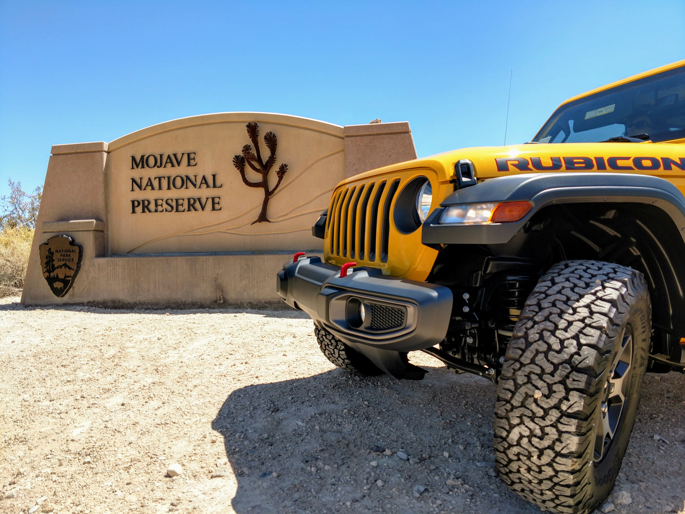 Yellow Jeep Rubicon at Mojave National Preserve entrance, perfect for an off-road RV rental adventure.