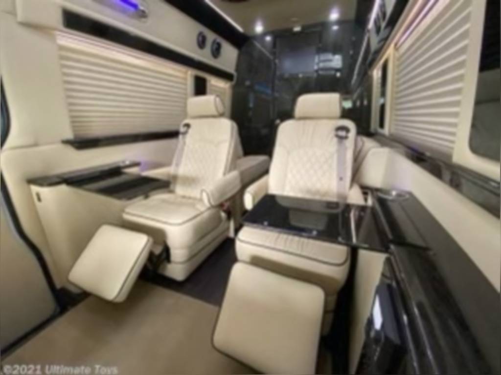 and elegant ambient lighting.|Plush RV rental interior featuring a stylish ceiling with large