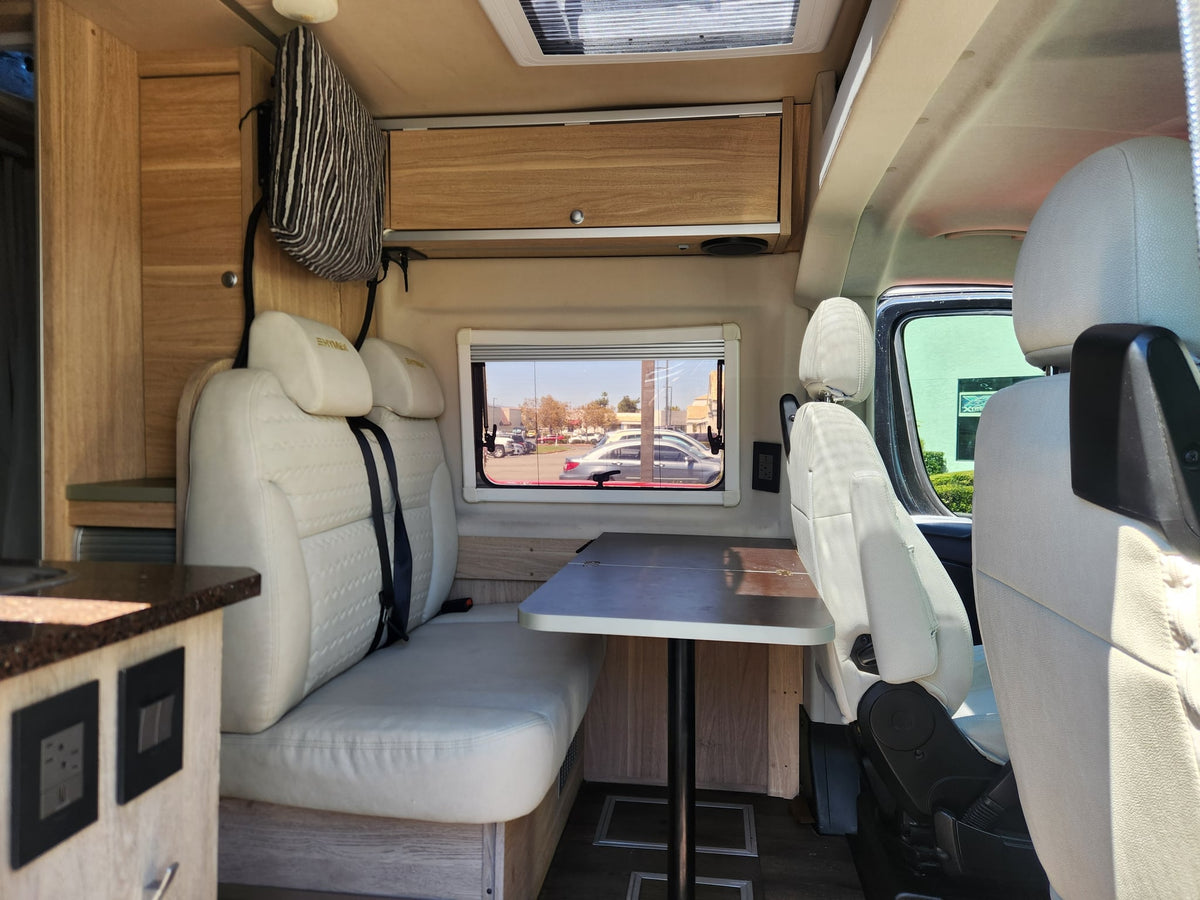parked at RockStar Used Cars of Temecula.|Open door view of a black RV rental interior: modern kitchen — photo 3
