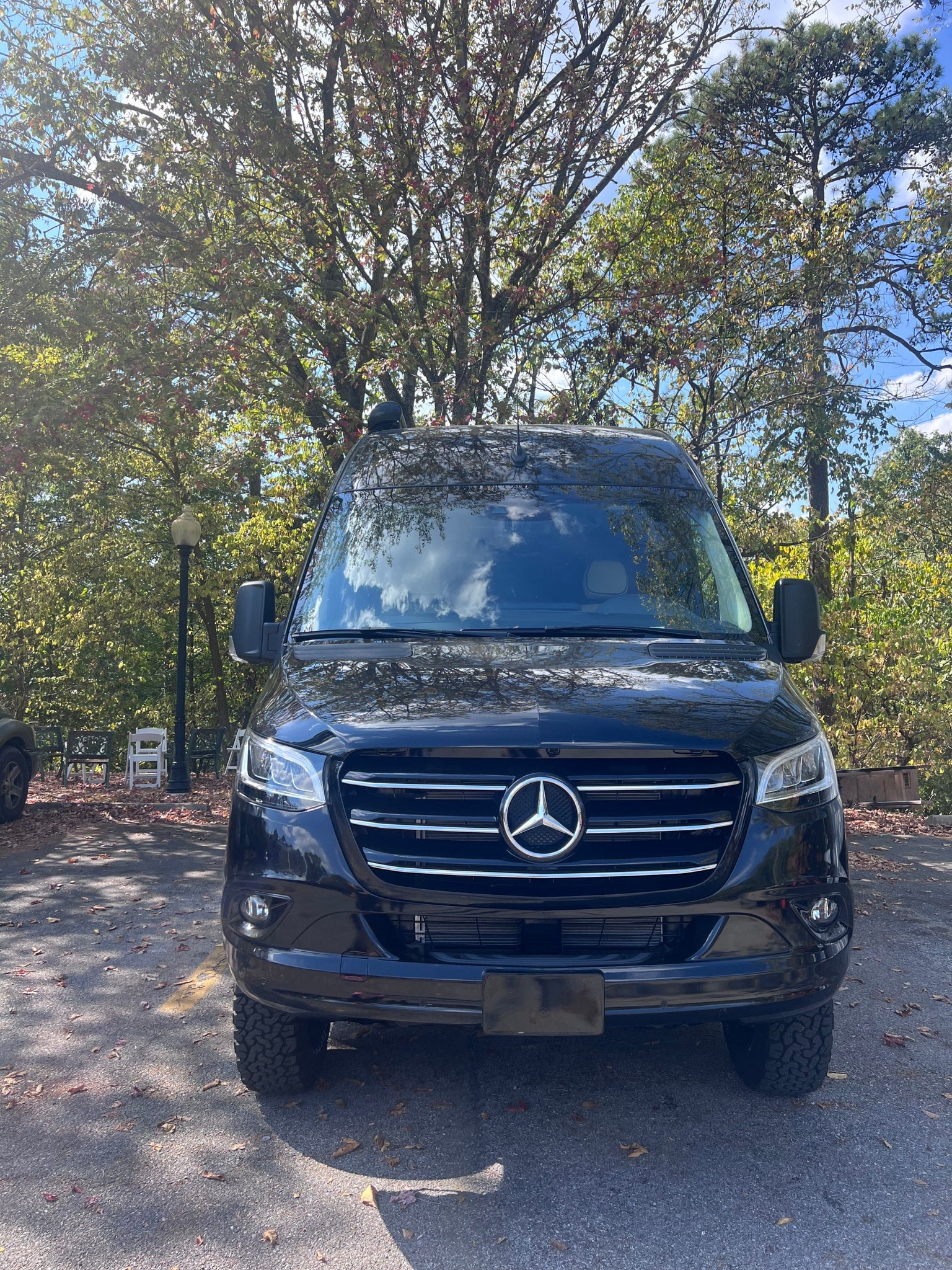 and quilted ceiling.|Explore this RV rental: a compact camper van interior with a toilet