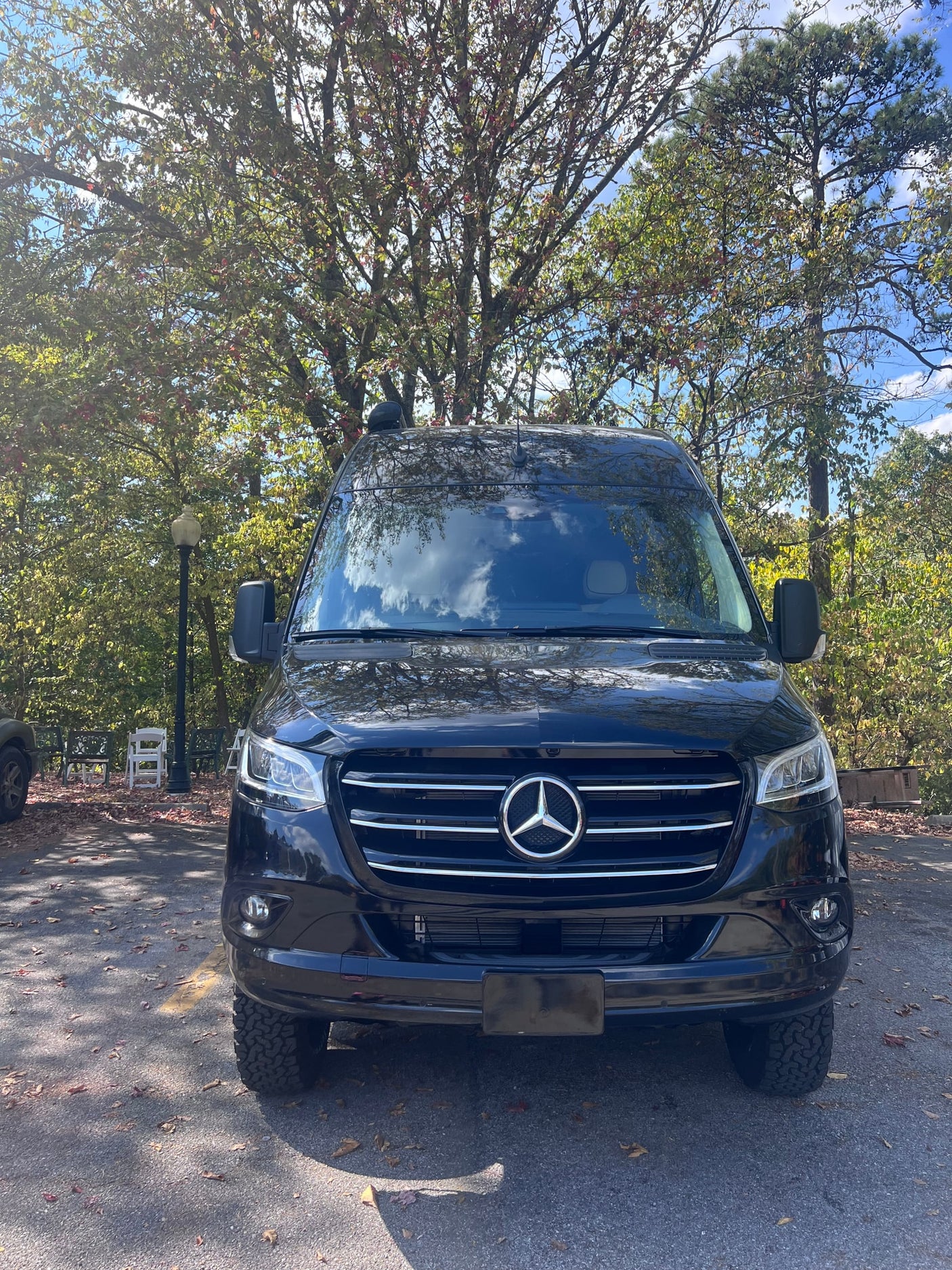 and quilted ceiling.|Explore this RV rental: a compact camper van interior with a toilet