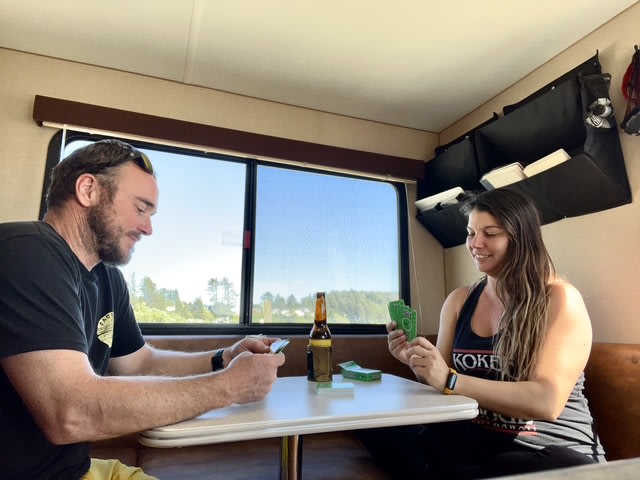and wall organizers. Two cans on table.|This rv rental kitchen has light wood cabinets — photo 8