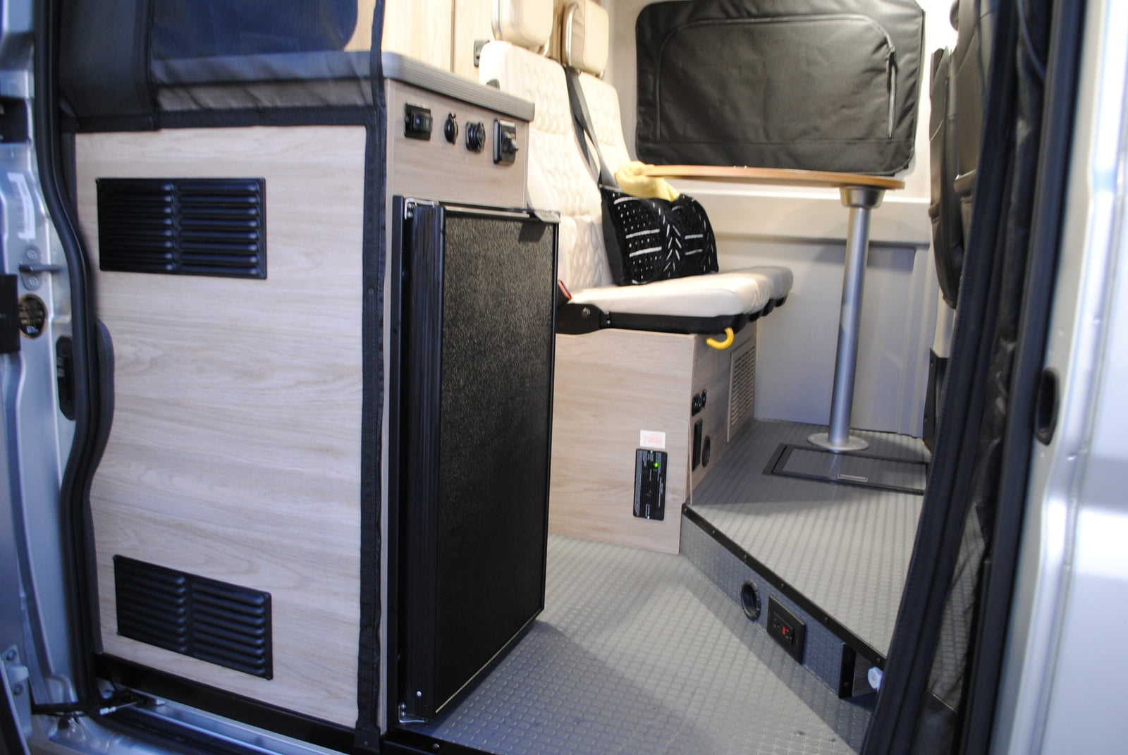 and mesh bug screens for comfortable travel.|This RV rental features a compact interior with a kitchenette (sink & stove)