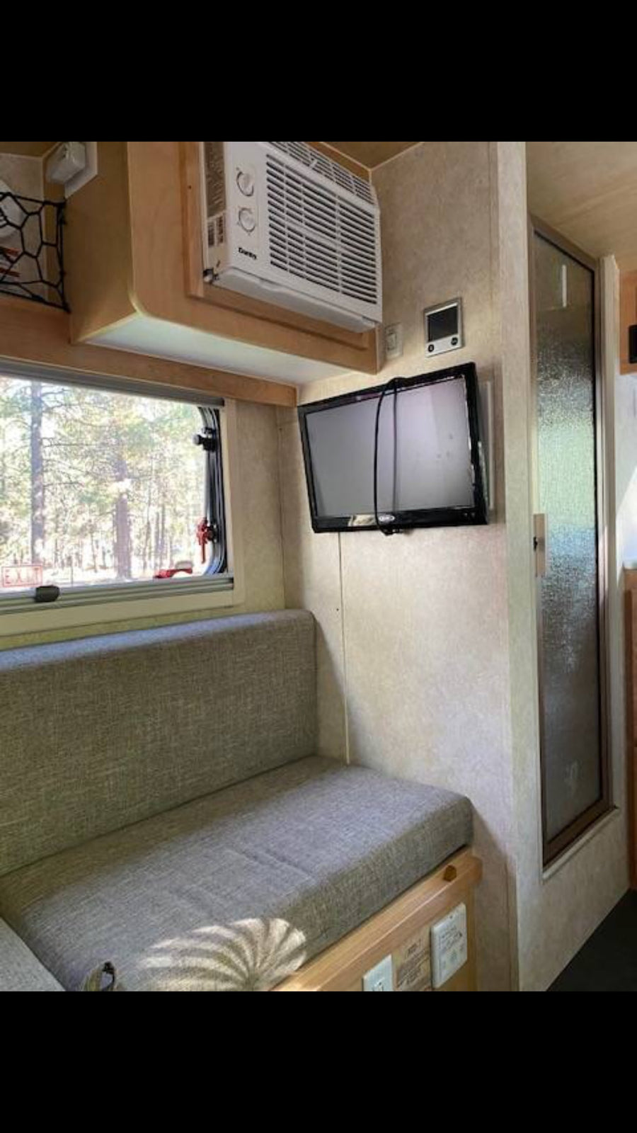 wood-paneled kitchenette with fridge