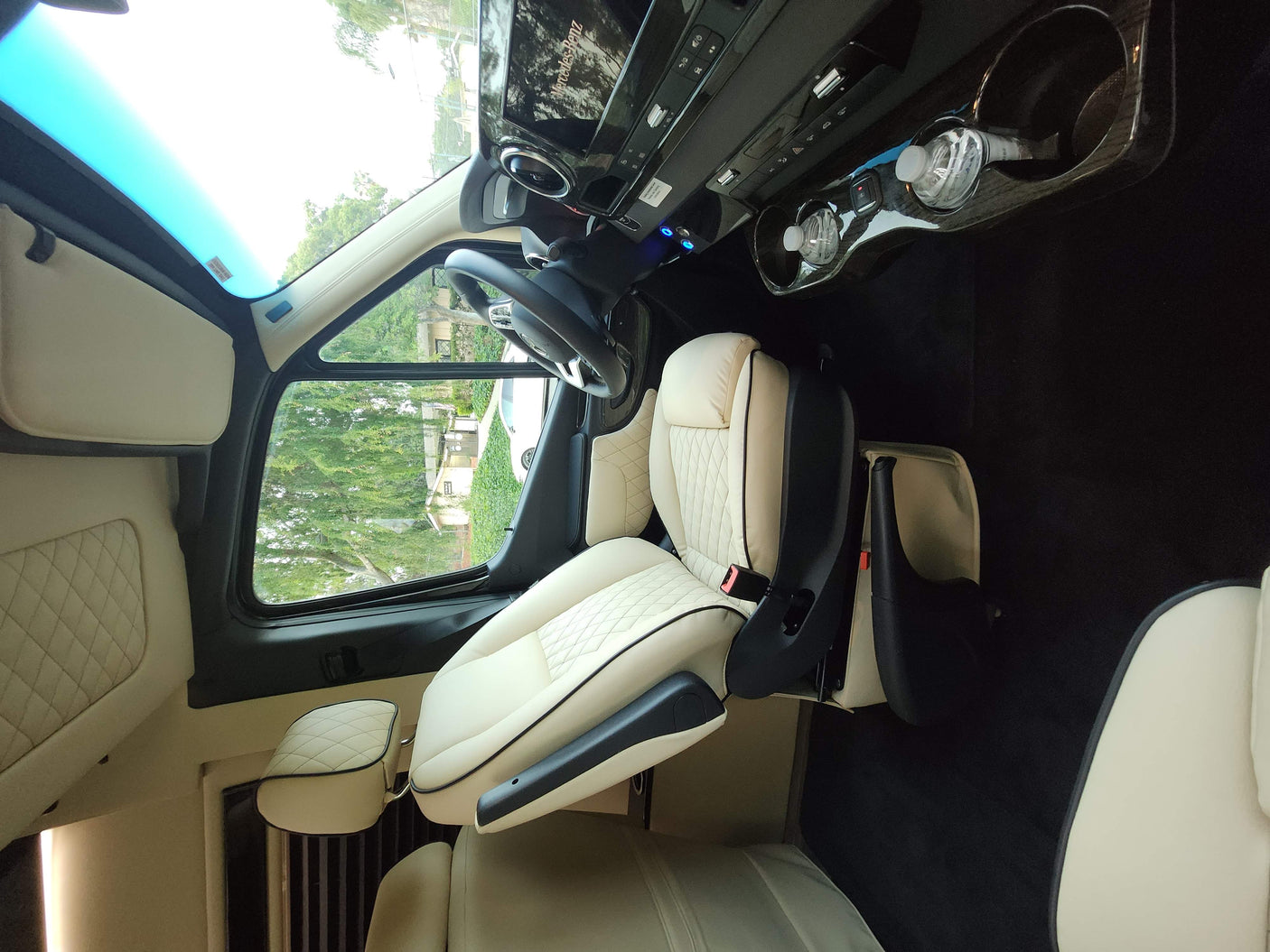 RV rental's luxurious Mercedes-Benz cabin features cream leather captain's chairs and a bright skylight.
