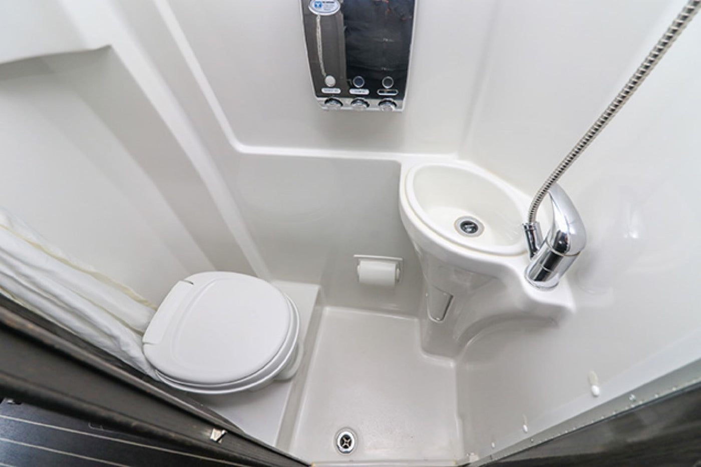 This RV rental's all-in-one compact bathroom features a toilet, sink, and shower, designed for efficient travel comfort. — photo 8