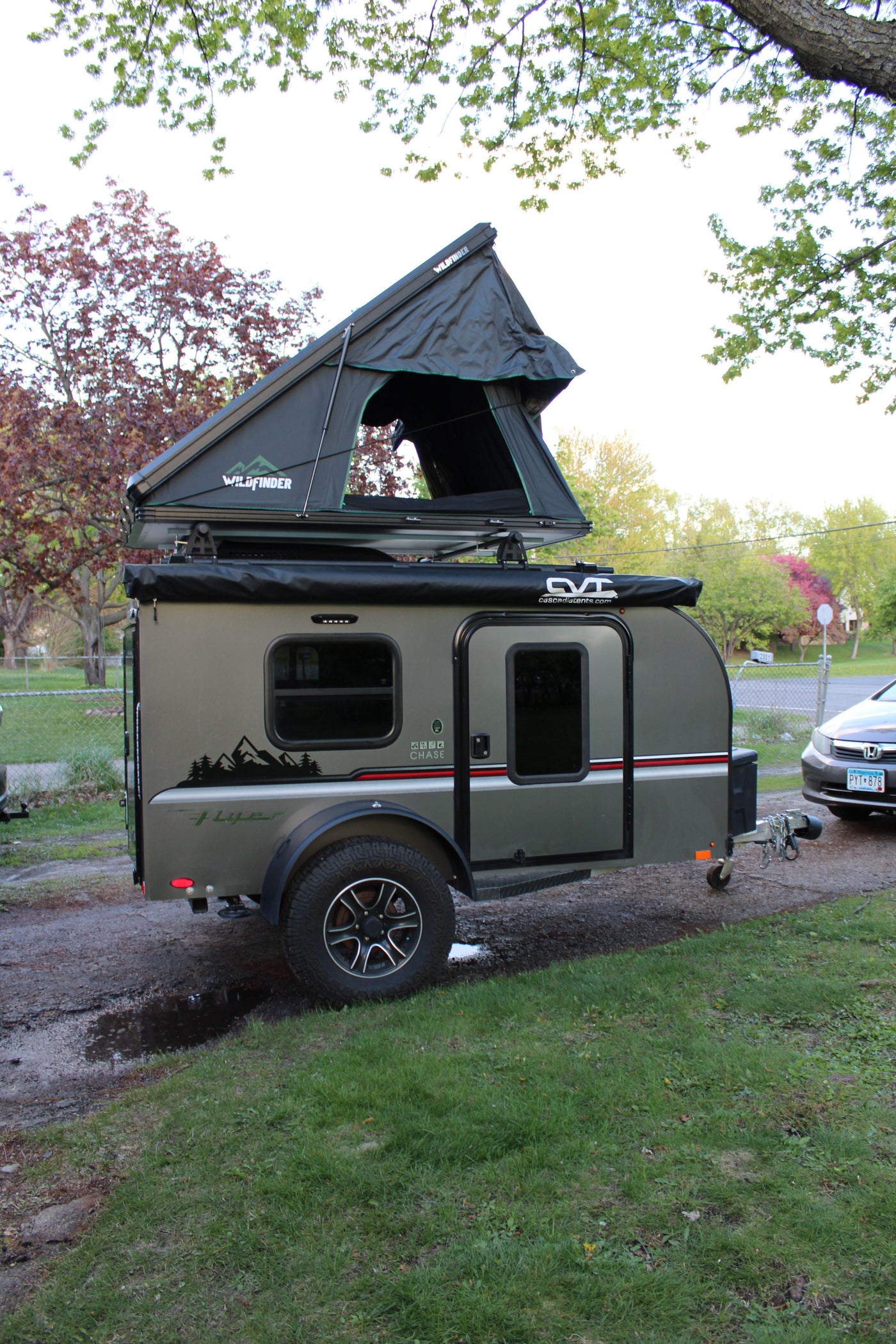 A sleek gray teardrop camper with a Wildfinder rooftop tent, ready for your next RV rental outdoor adventure. — photo 1