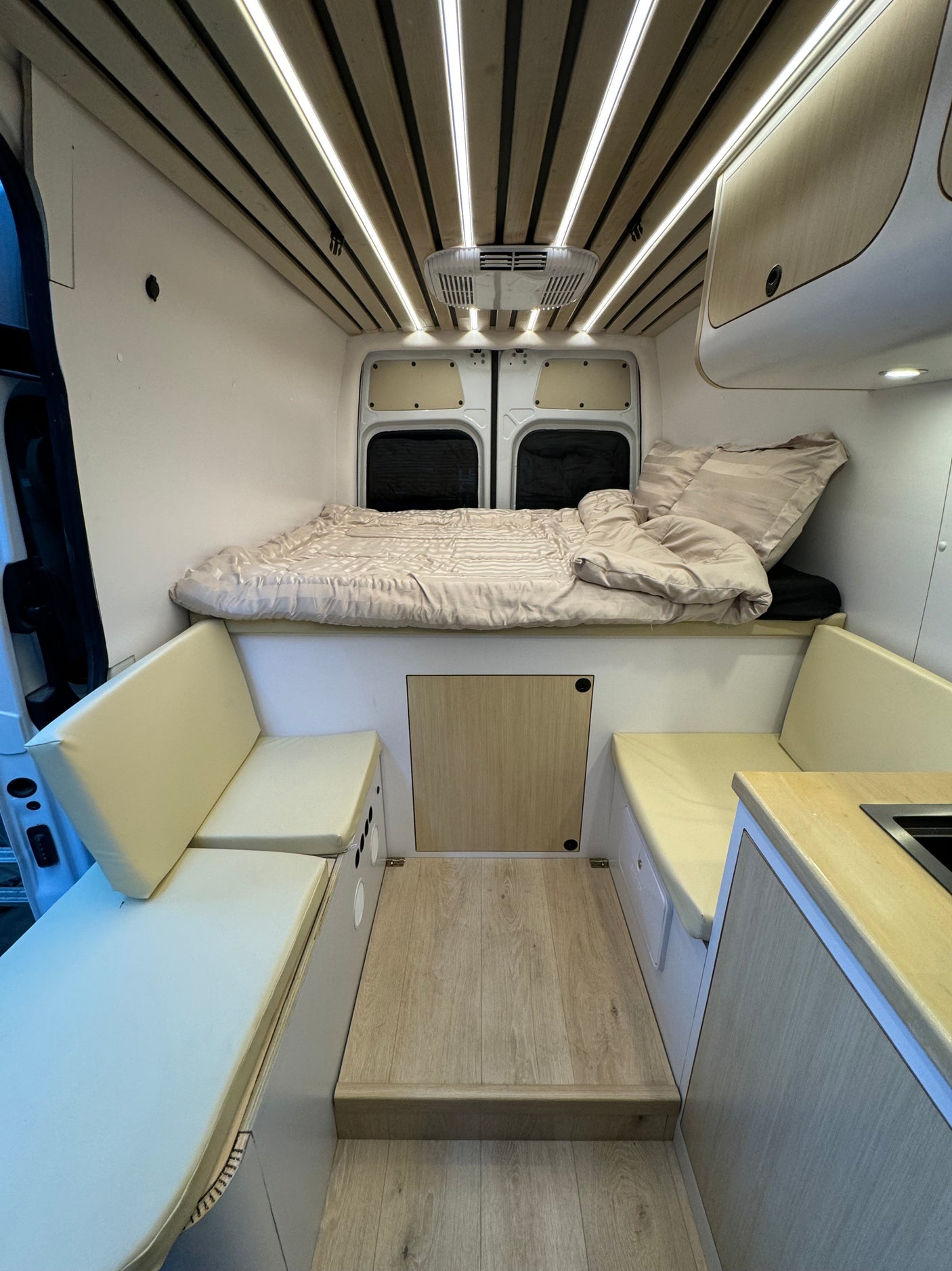 Step inside this clean, modern RV rental. Enjoy the cozy bed, bench seating, and compact kitchen.