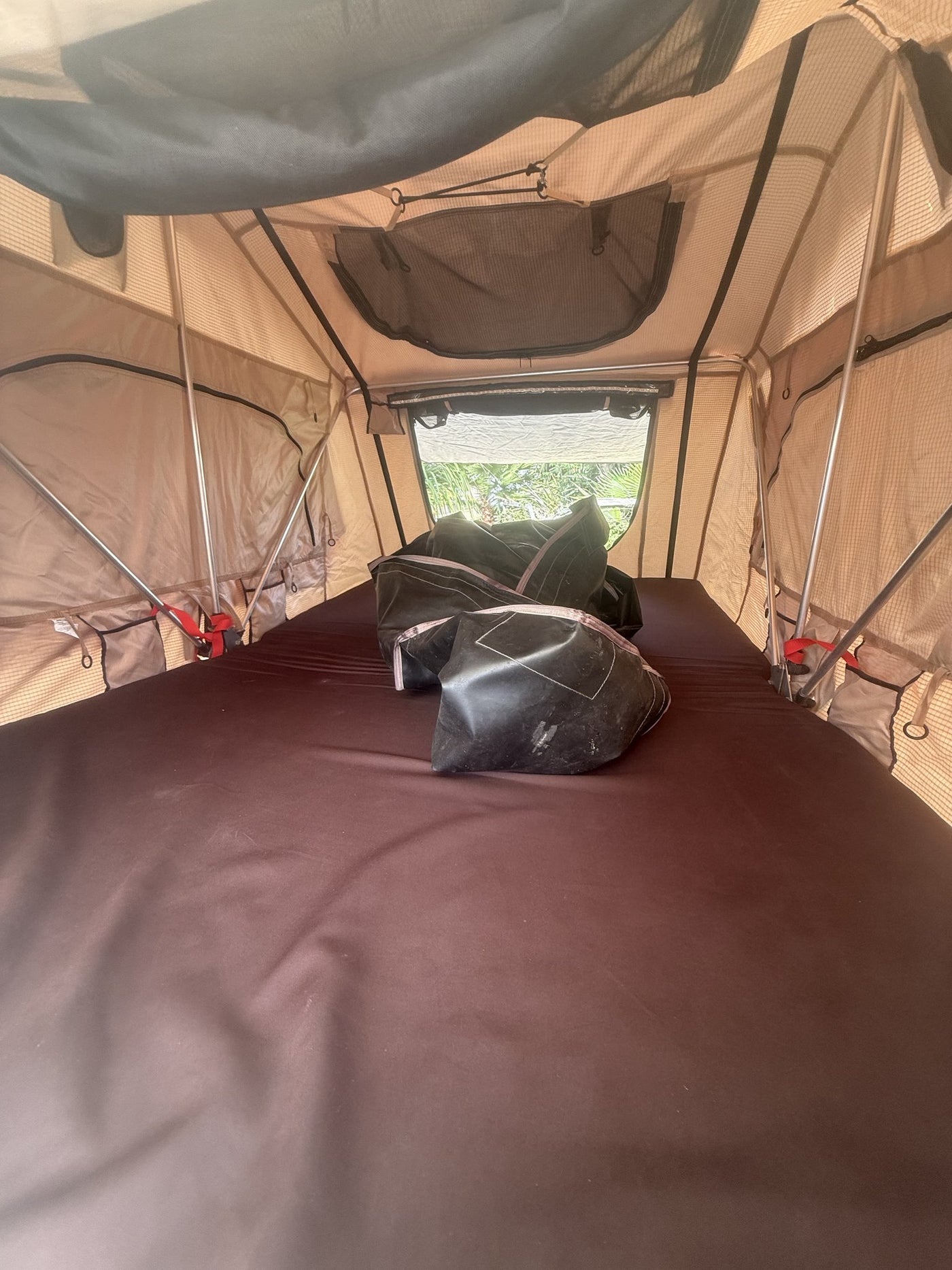 Wide interior view of the mattress, mesh windows and internal frame poles with the tent open — photo 10