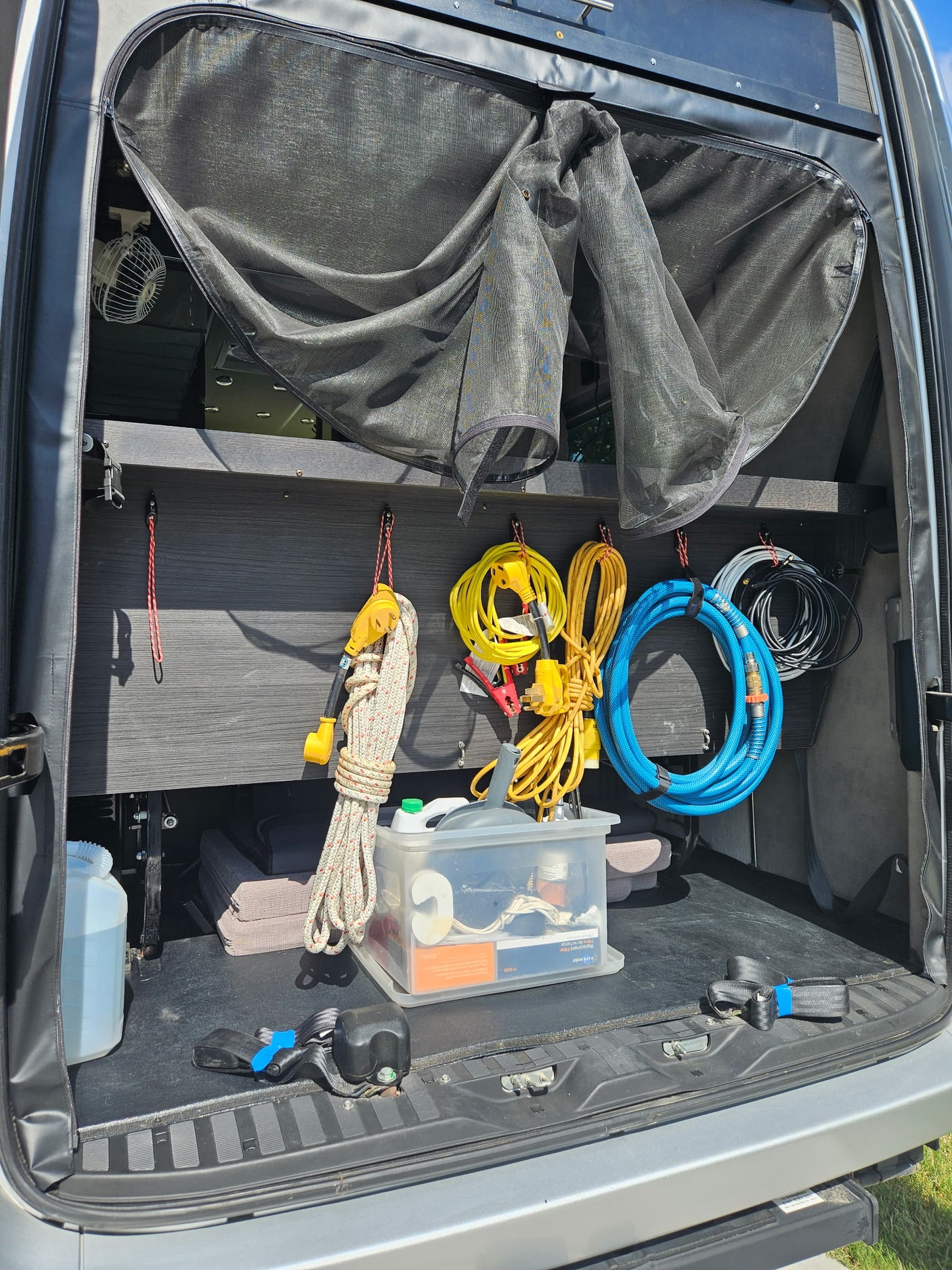 and a stainless steel spice rack. Bright windows illuminate the compact galley.|RV rental Dometic climate control set to cool at 68°F in auto mode