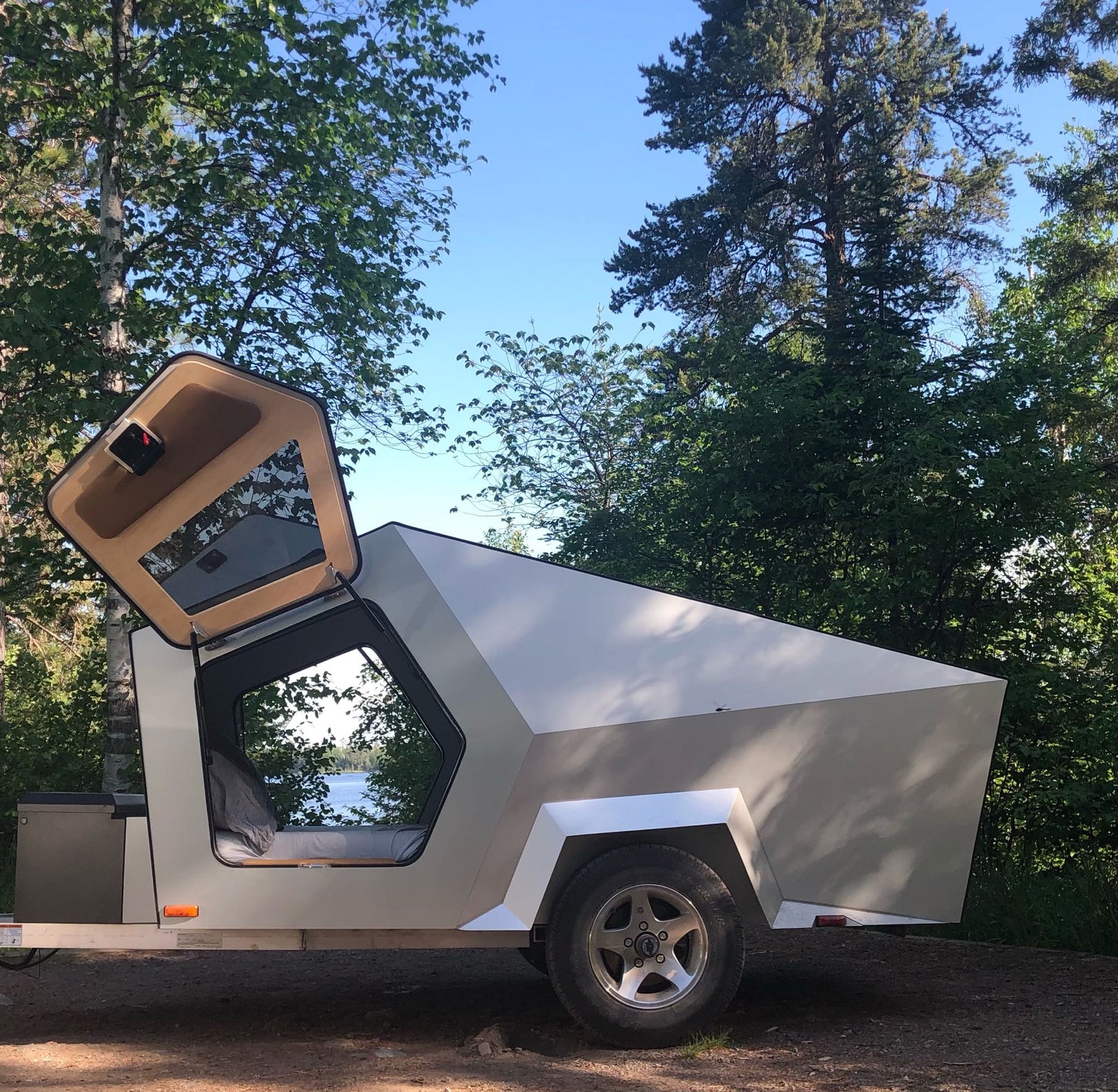and smart storage.|An RV rental features an outdoor kitchen with a camping stove