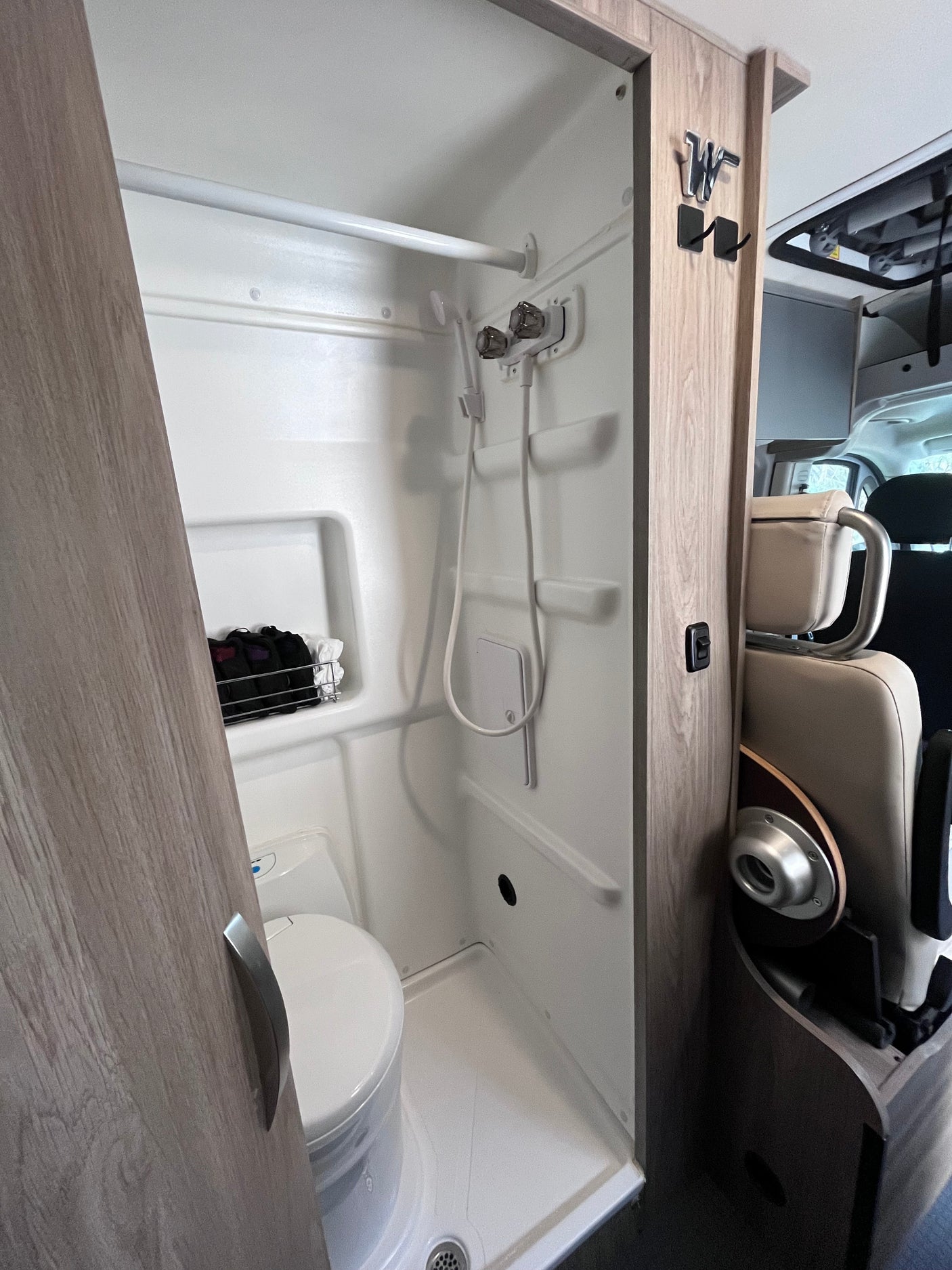 This RV rental features a compact, integrated wet-bath with a shower, toilet, and convenient storage for your adventure.