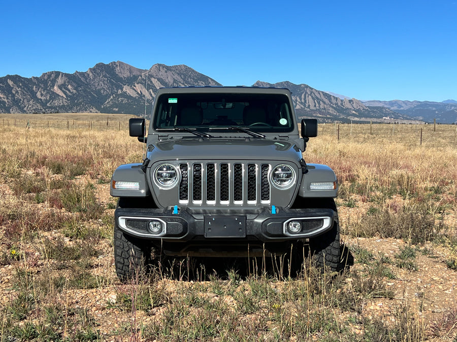 Rugged grey Jeep Wrangler in a dry mountain field. Your adventure vehicle, perfect for any rv rental trip.