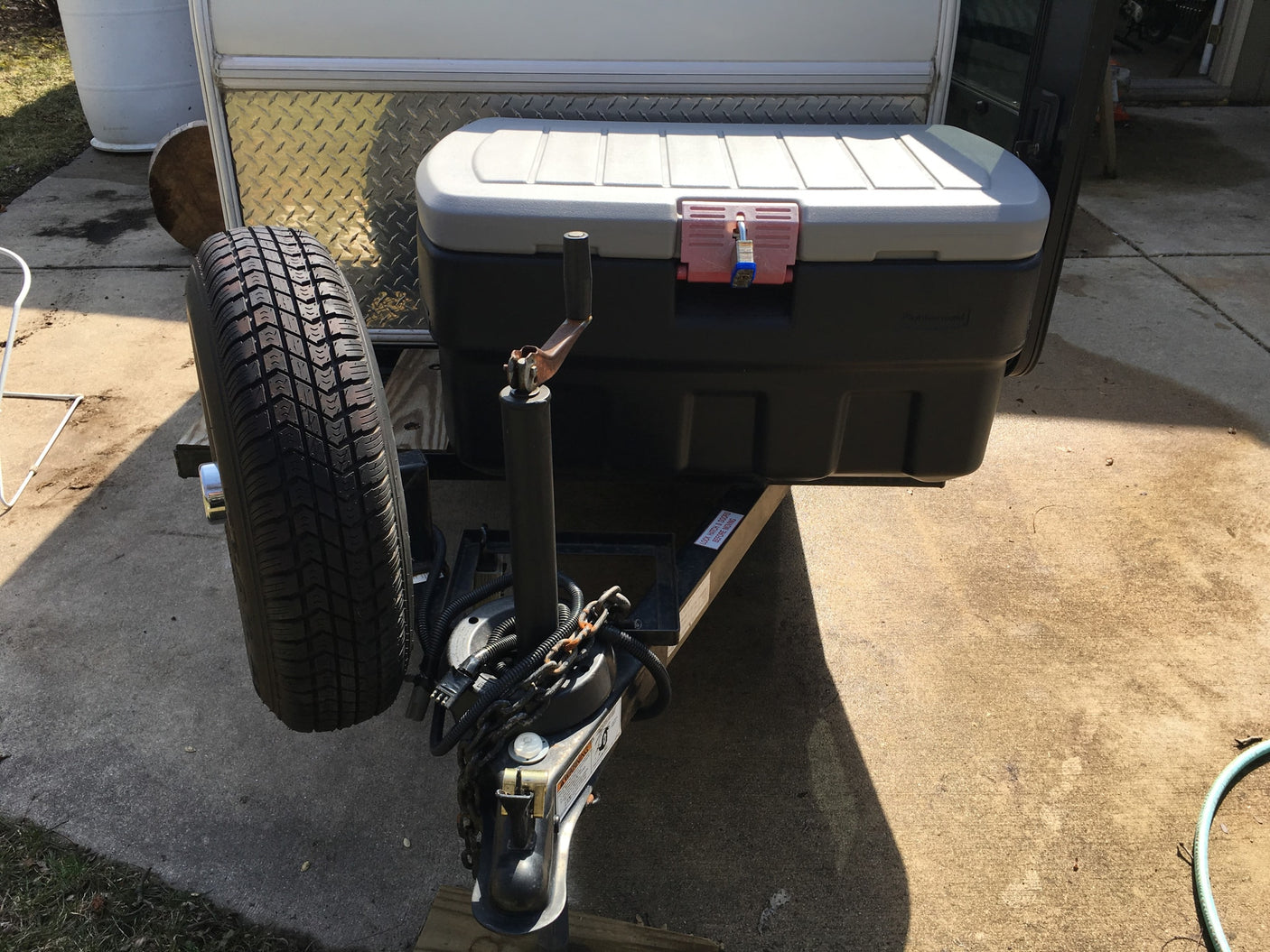 RV rental: Travel trailer front with spare tire, locked storage box, & hitch. Adventure ready!