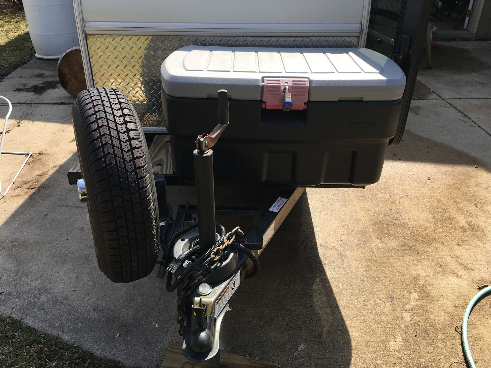 RV rental: Travel trailer front with spare tire, locked storage box, & hitch. Adventure ready!