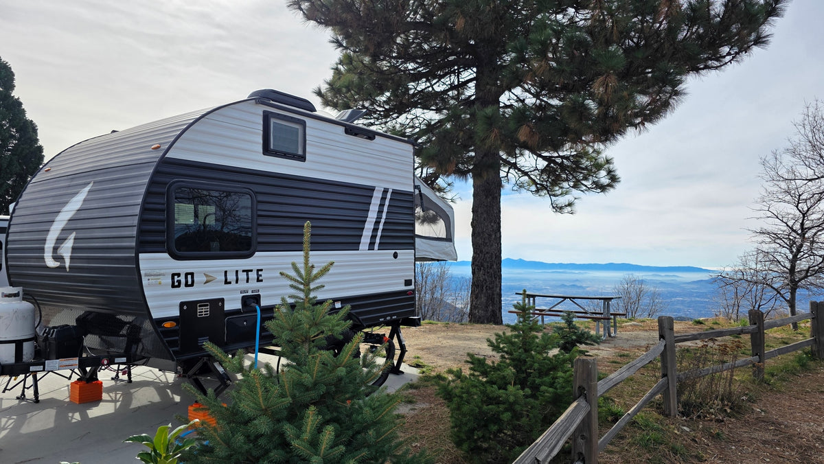 Enjoy this Go-Lite RV rental at a scenic mountain campsite overlooking a hazy valley and distant peaks. — photo 14