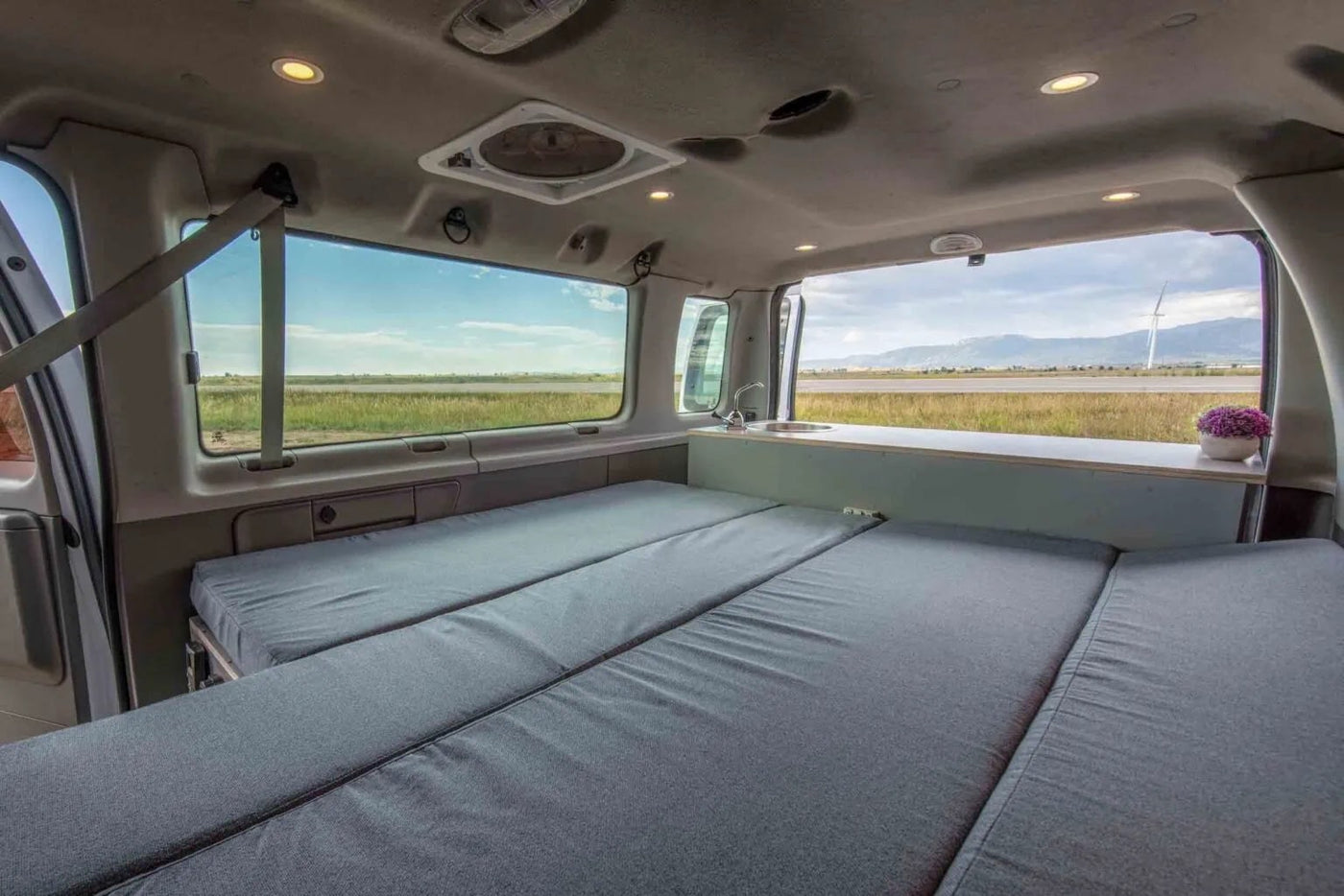 perfect for an rv rental.|Explore this RV rental's spacious interior: grey cushioned beds/seating — photo 11
