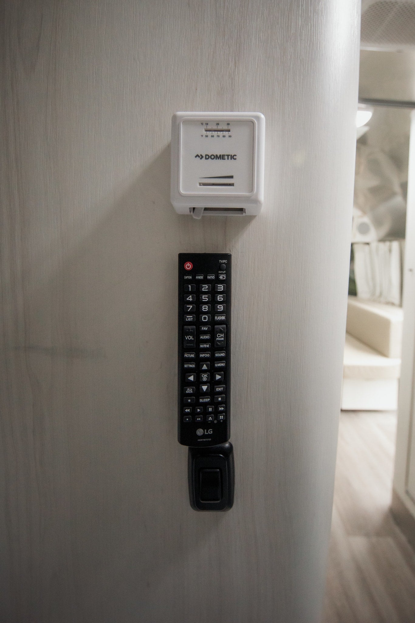 Control your comfort in this rv rental with the Dometic thermostat and LG remote mounted on the wall.