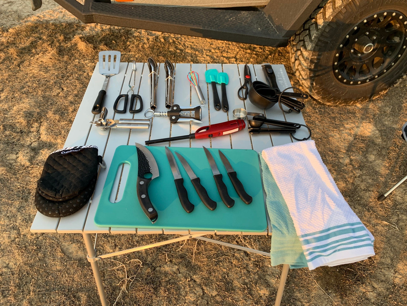 Outdoor kitchen setup with assorted utensils and tools, perfect for an RV rental adventure.