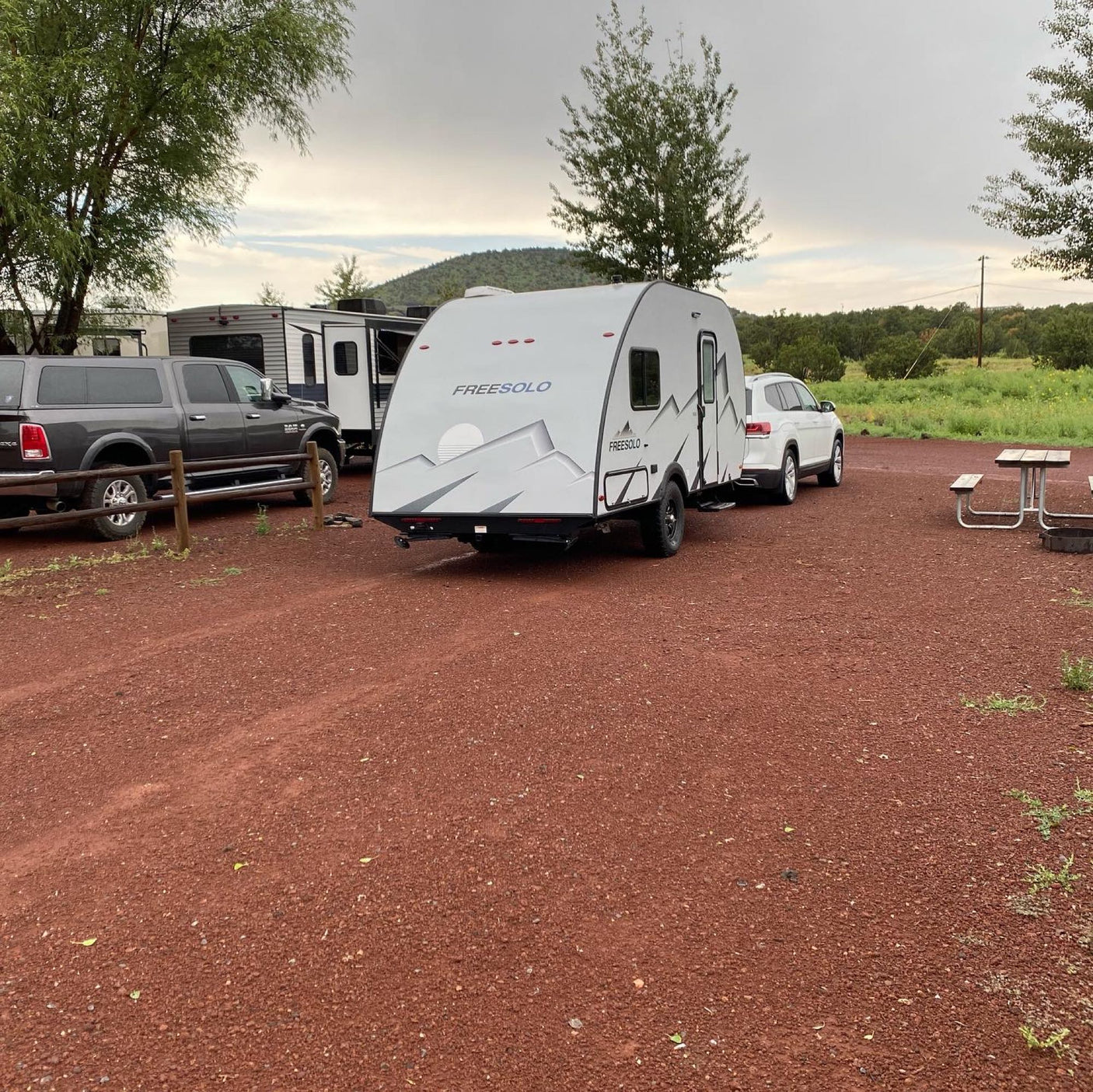 a compact teardrop travel trailer glowing invitingly.|This RV rental site features a FREESOLO travel trailer