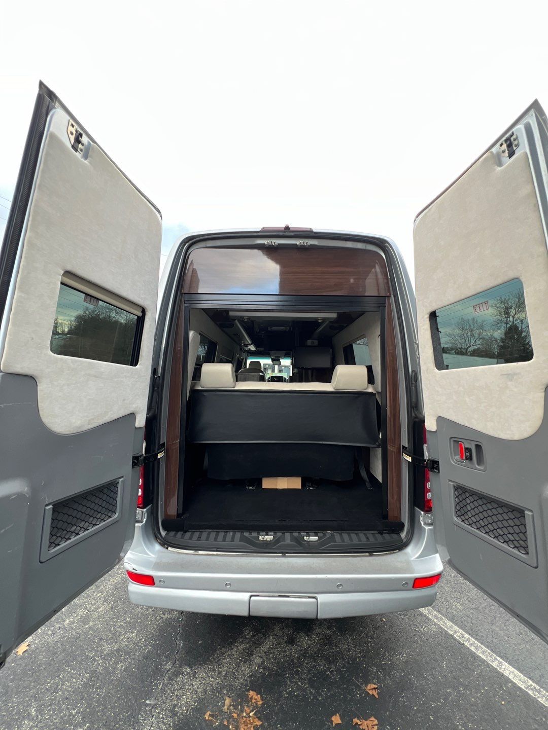 and entertainment monitor.|Luxury RV rental interior: Cream captain's chairs