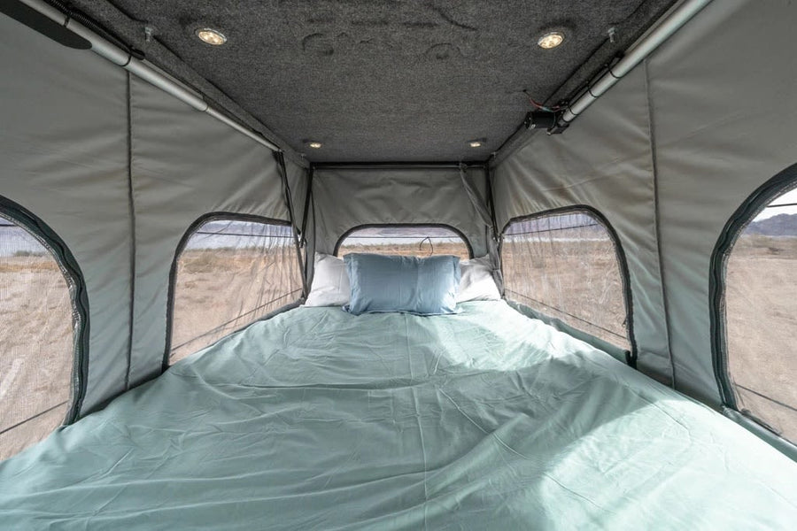 and gear shifter.|Cozy RV rental interior with pop-top