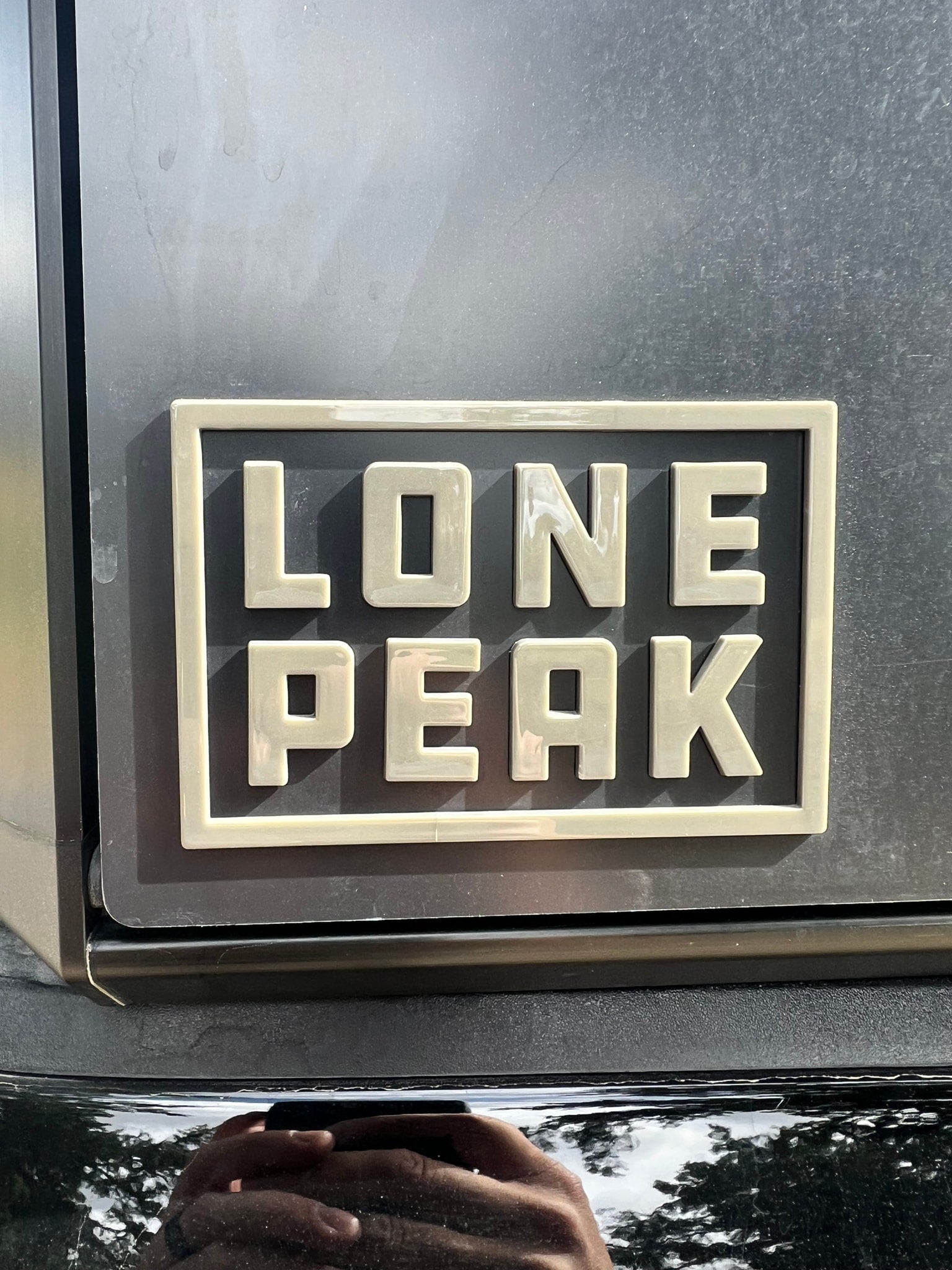 Durable "Lone Peak" emblem on an RV rental, hinting at scenic mountain journeys.