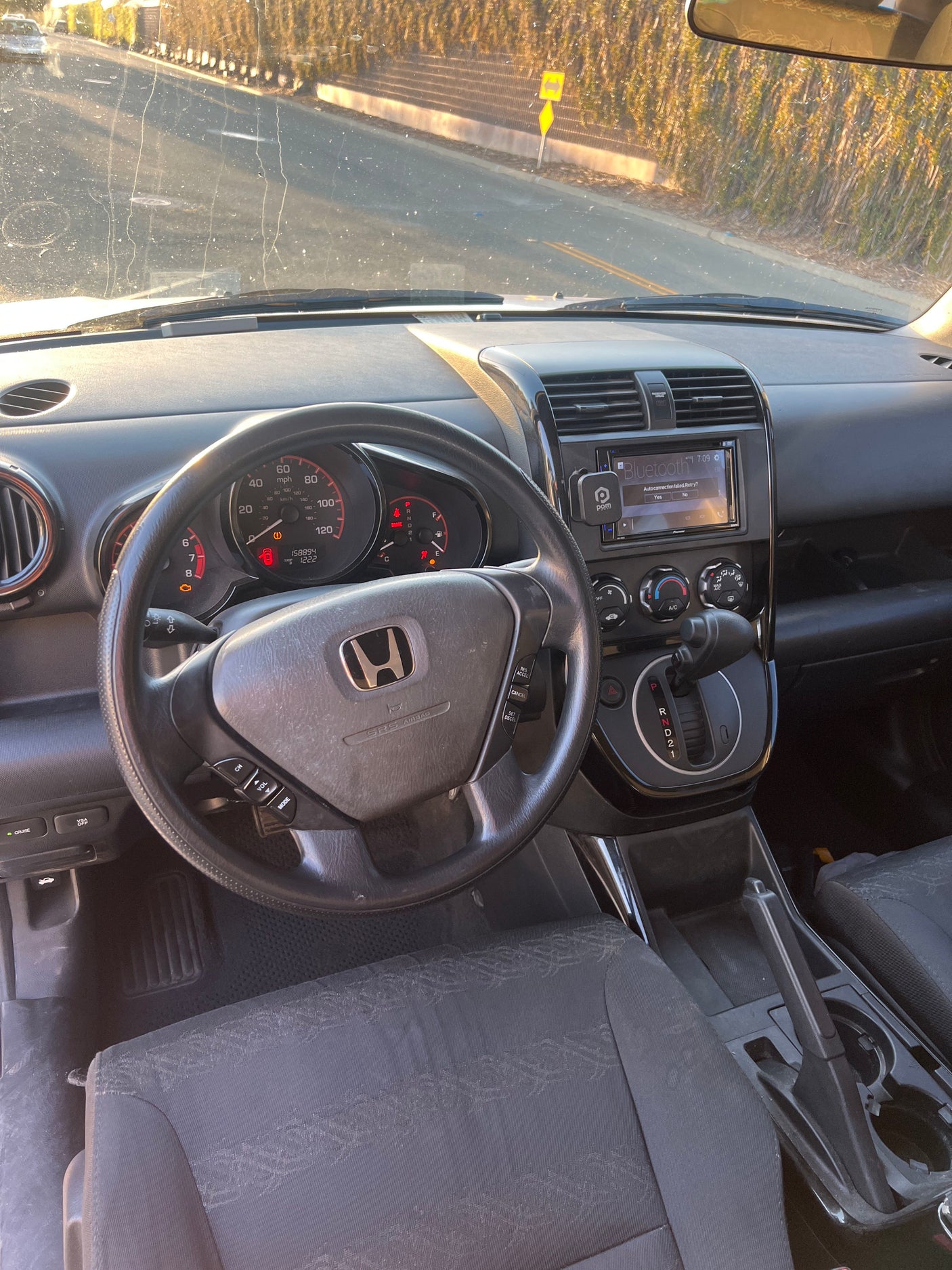 Car interior with dashboard, steering wheel, and road visible. Great for a road trip; think about this option versus an rv rental.