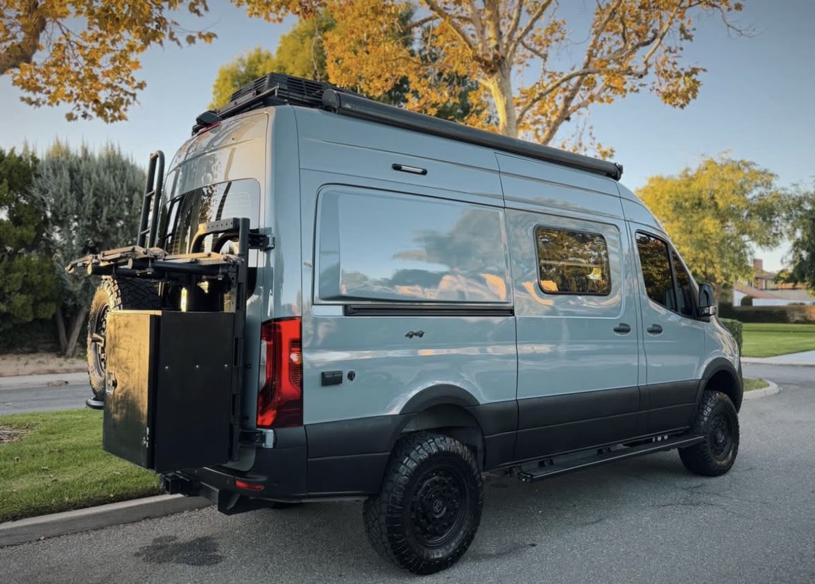 Adventure-ready gray camper van with off-road tires, roof rack & rear storage. Perfect for your RV rental journey. — photo 11