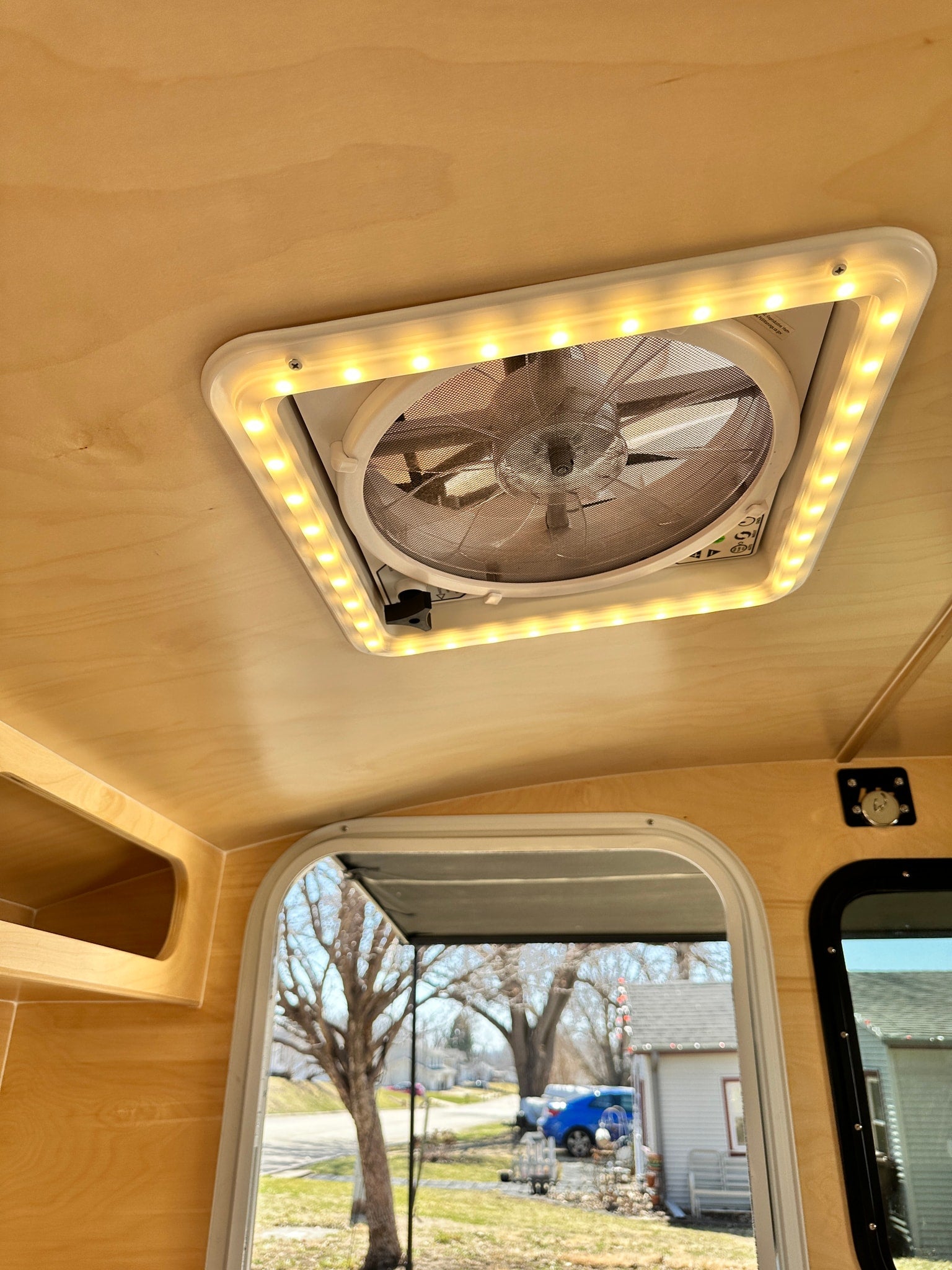 and awning.|A white Hiker Trailer RV rental is parked with a blue pickup truck on a sunny driveway
