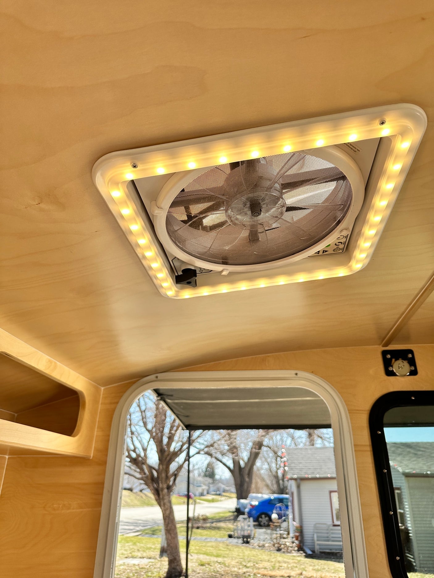and awning.|A white Hiker Trailer RV rental is parked with a blue pickup truck on a sunny driveway