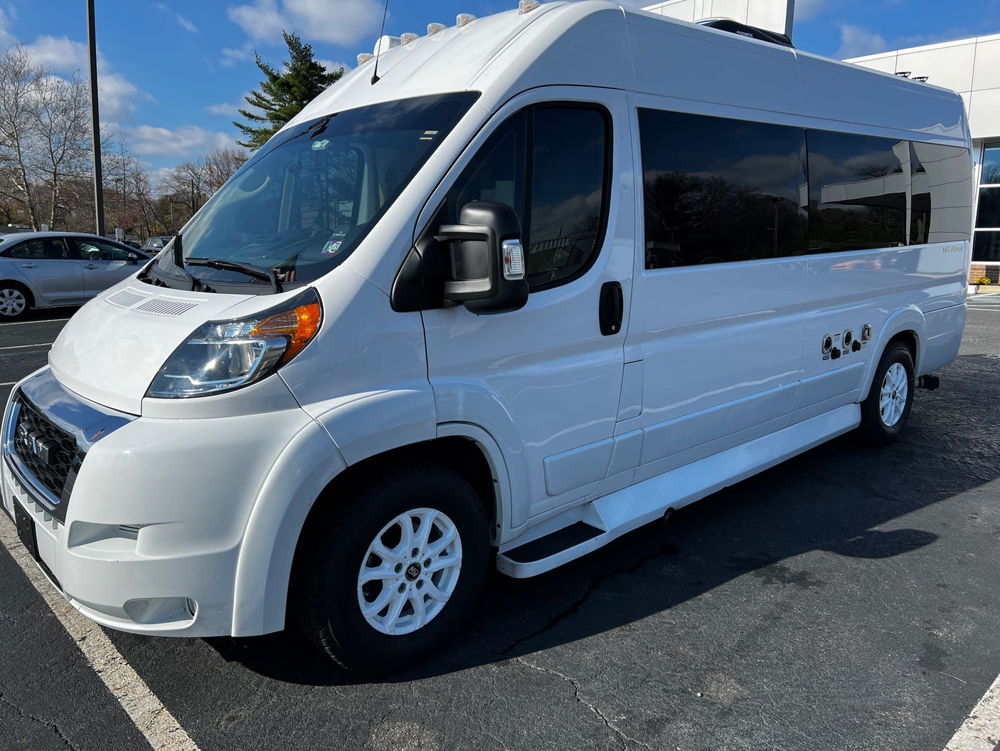 White Class B camper van, a sleek option for rv rental, shown parked outside on a sunny day.