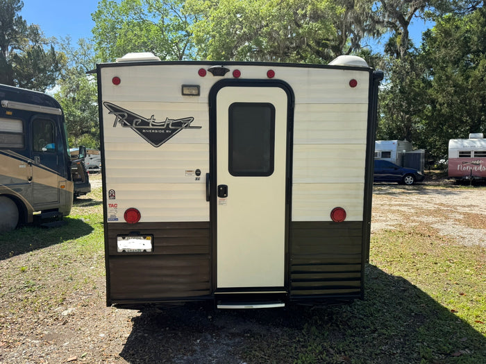 parked outdoors.|A white and black Retro travel trailer