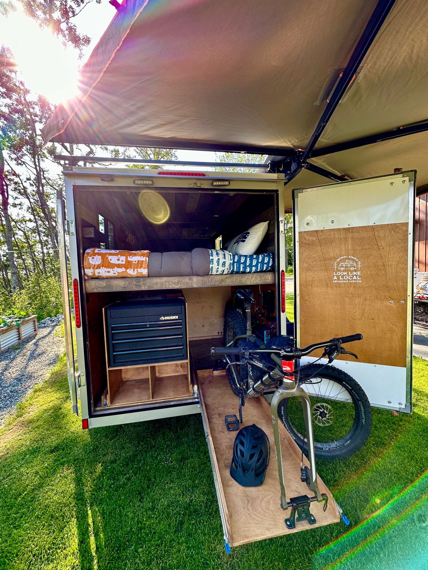 This open cargo trailer RV rental features bunk beds