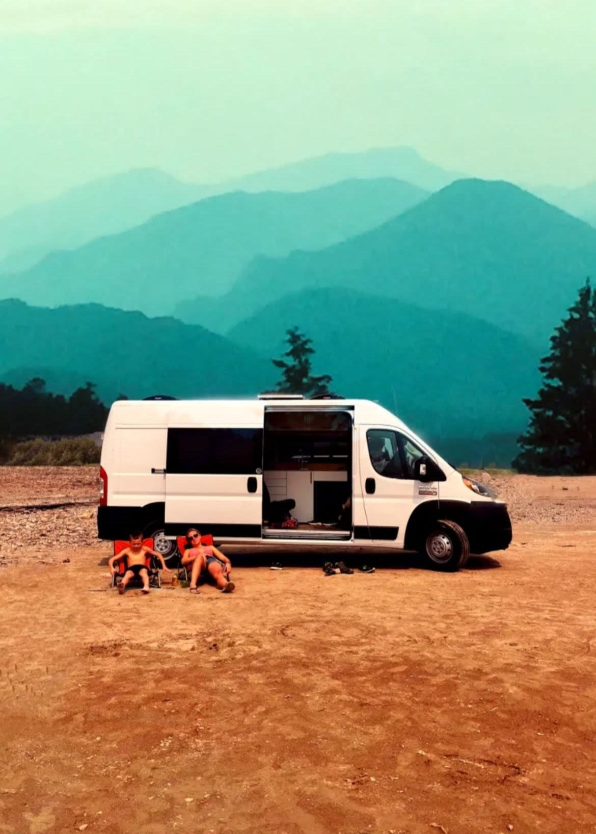 Family relaxing by their RV rental camper van