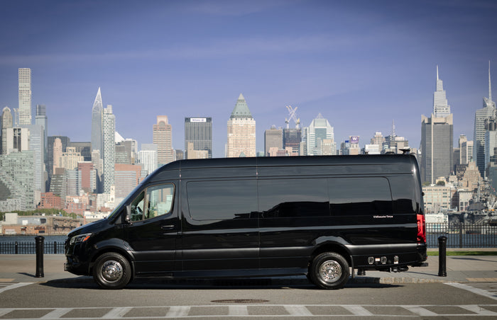parked before a stunning city skyline.|Sleek black Mercedes-Benz Sprinter RV rental parked with a vibrant NYC skyline background. Ideal for luxury travel.|Cream-colored