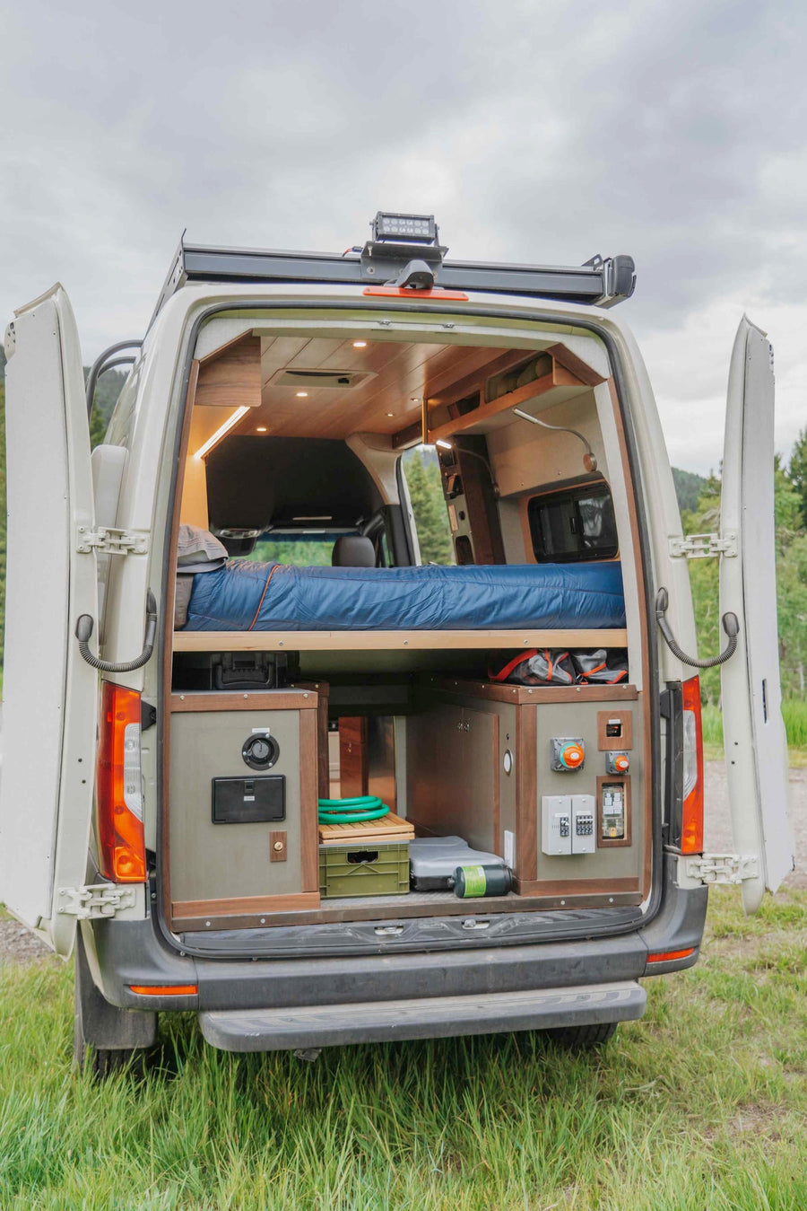 and forest backdrop.|Inside a cozy RV rental: sleek kitchen with sink