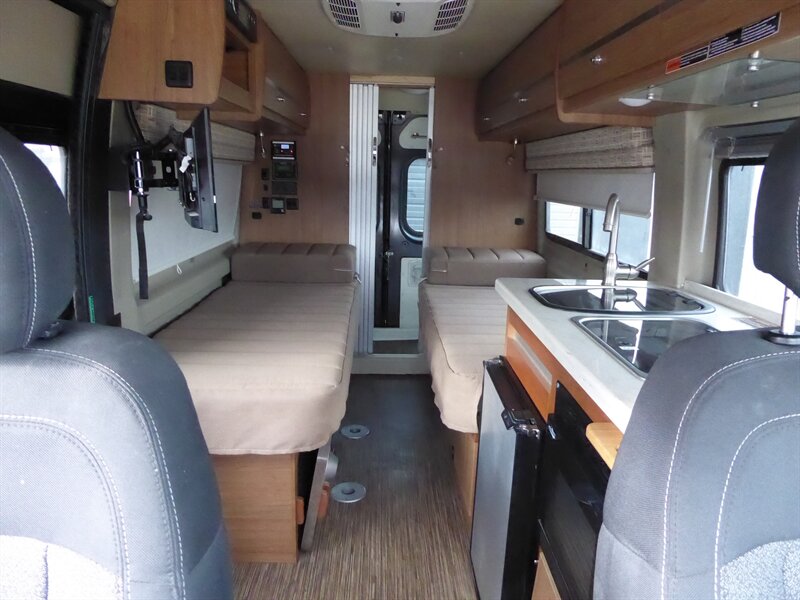 and "TRAVATO" logo on the rear.|Dark gray Travato RV rental van