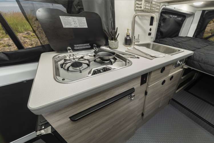 and a rear bug screen.|This RV rental interior features a shower stall with toilet