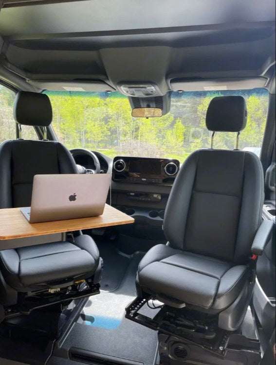 RV rental interior: Swivel seats, portable table, and laptop create a flexible, mobile workspace in this van. — photo 4