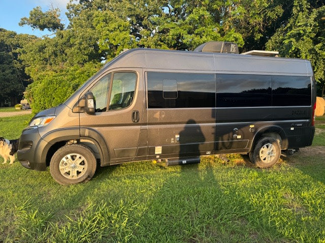 Sleek gray Dazzle Class B RV rental parked on grass