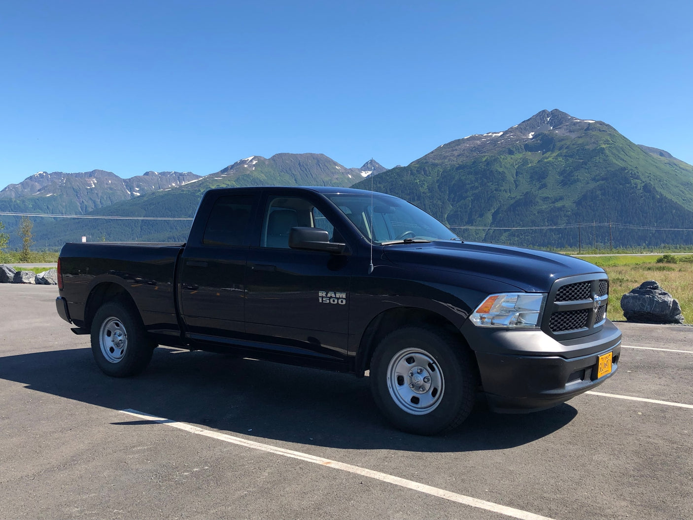 showing a Target store parking lot with cars.|A black Ram 1500 pickup truck parked in a shopping center lot